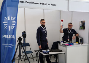 Policjanci na stoisku rozmawiający z uczestnikami targów