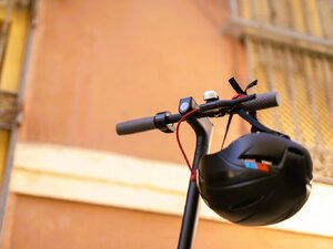 Kask zawieszony na kierownicy hulajnogi